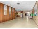 Large living room with kitchen and screened porch views at 11451 Pala Verda Ave, Leesburg, FL 34788