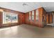 Spacious living area with wood paneling and large window at 11451 Pala Verda Ave, Leesburg, FL 34788