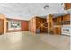 Open living room and kitchen area with wood paneling at 11451 Pala Verda Ave, Leesburg, FL 34788