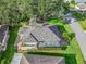 Top-down view of the home's roof and screened porch, nestled in a green, tree-lined neighborhood at 11584 Se 175Th St, Summerfield, FL 34491