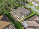 An aerial view showcasing the home's roof, screened-in lanai, and backyard at 11584 Se 175Th St, Summerfield, FL 34491
