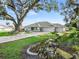 Inviting home exterior with a paved driveway, attached two-car garage, and well-maintained landscaping at 11584 Se 175Th St, Summerfield, FL 34491