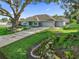 Home exterior with mature oak trees and well-maintained landscape beds at 11584 Se 175Th St, Summerfield, FL 34491