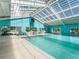 Indoor pool with retractable roof, ideal for year-round swimming at 11584 Se 175Th St, Summerfield, FL 34491