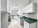 Laundry room with ample counter space, cabinets, and tile flooring at 11584 Se 175Th St, Summerfield, FL 34491