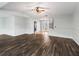 Bright living room with dark wood-look floors and entryway to other rooms at 11584 Se 175Th St, Summerfield, FL 34491