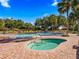 Community pool with hot tub, lounge chairs, and umbrellas at 11584 Se 175Th St, Summerfield, FL 34491