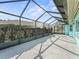 Long screened patio with bushes and trees along side at 11584 Se 175Th St, Summerfield, FL 34491