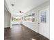 Sunroom with many windows, wood-look floors, and access to backyard at 11584 Se 175Th St, Summerfield, FL 34491