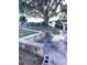 Backyard featuring a sitting area, dock, and large oak tree at 12141 Lake Pines Rd, Leesburg, FL 34788