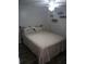 Simple bedroom featuring neutral colors and wood-look flooring at 12141 Lake Pines Rd, Leesburg, FL 34788