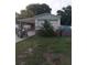 Front exterior of a single-Gathering home with a carport and landscaped yard at 12141 Lake Pines Rd, Leesburg, FL 34788
