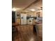 Bright kitchen with white appliances, wood-look flooring, and a dining area at 12141 Lake Pines Rd, Leesburg, FL 34788