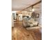 Open living area with light wood floors, ceiling fan and comfortable seating at 12141 Lake Pines Rd, Leesburg, FL 34788