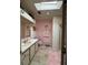 Bathroom with pink walls, shower, and vanity at 1335 E Schwartz Blvd, Lady Lake, FL 32159