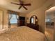 Main bedroom with king-size bed and access to another room at 1335 E Schwartz Blvd, Lady Lake, FL 32159