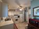 Galley style kitchen with white cabinets and appliances at 1335 E Schwartz Blvd, Lady Lake, FL 32159