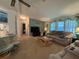 Bright and airy living room with ample seating and a view of the bedroom at 1335 E Schwartz Blvd, Lady Lake, FL 32159