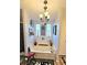 Charming bathroom with a garden tub, chandelier, and decorative wall art at 1715 Lilly Ln, Lady Lake, FL 32159