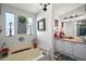 Bathroom with a soaking tub, single vanity, and decorative accents at 1715 Lilly Ln, Lady Lake, FL 32159