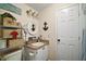 Powder room featuring nautical-themed decor and a white vanity at 1715 Lilly Ln, Lady Lake, FL 32159
