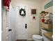 Powder room with holiday decorations and a striped shower curtain at 1715 Lilly Ln, Lady Lake, FL 32159