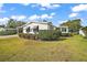 Inviting front yard with well-maintained landscaping and a welcoming walkway at 1715 Lilly Ln, Lady Lake, FL 32159