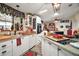Open kitchen with white cabinets, butcher block counters, and holiday decorations at 1715 Lilly Ln, Lady Lake, FL 32159