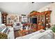 Cozy living room with large entertainment center and comfortable seating at 1715 Lilly Ln, Lady Lake, FL 32159