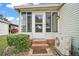 Enclosed side entrance with brick steps and lush landscaping at 1715 Lilly Ln, Lady Lake, FL 32159