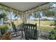 Relaxing sunroom with rocking chairs and serene golf course views at 1715 Lilly Ln, Lady Lake, FL 32159