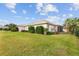 Landscaped backyard with lush green grass and palm trees at 17549 Se 88Th Covington Cir, The Villages, FL 32162