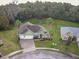 An aerial view of a charming home with a two-car garage, landscaped yard, and circular driveway at 3556 Creek Run Ln, Eustis, FL 32736