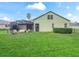 Large, fenced backyard with lush lawn and screened-in patio at 3556 Creek Run Ln, Eustis, FL 32736