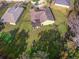 Aerial view of the fenced backyard, featuring a screened-in porch and a playset at 3556 Creek Run Ln, Eustis, FL 32736