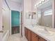 Double vanity sinks with wooden cabinets in a pink bathroom at 3556 Creek Run Ln, Eustis, FL 32736