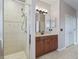 Bathroom with walk-in shower, double vanity, and tiled flooring at 3556 Creek Run Ln, Eustis, FL 32736