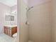 Tiled shower with chrome fixtures in a pink bathroom at 3556 Creek Run Ln, Eustis, FL 32736