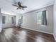 Spacious bedroom with wood-look flooring, ceiling fan, and windows with blinds at 3556 Creek Run Ln, Eustis, FL 32736