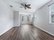 Spacious bedroom with wood-look flooring, ceiling fan, and multiple windows with blinds at 3556 Creek Run Ln, Eustis, FL 32736