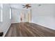 Bedroom with wood-look flooring, ceiling fan, and ensuite bathroom access at 3556 Creek Run Ln, Eustis, FL 32736