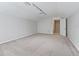 Large bonus room with carpeted flooring and access to stairs at 3556 Creek Run Ln, Eustis, FL 32736