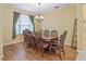 Dining room with a wood table, matching chairs, and hardwood floors at 3556 Creek Run Ln, Eustis, FL 32736