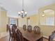 Dining room with wood floors, chandelier lighting, and a view of the living room at 3556 Creek Run Ln, Eustis, FL 32736