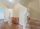 Inviting foyer with wood-look flooring, staircase, and access to other living areas at 3556 Creek Run Ln, Eustis, FL 32736