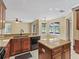 Open kitchen with island, black appliances, and view of dining area at 3556 Creek Run Ln, Eustis, FL 32736