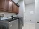 Laundry room with washer, dryer, and wood cabinets at 3556 Creek Run Ln, Eustis, FL 32736