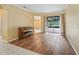 Living room with hardwood floors, a piano, and access to the backyard and dining area at 3556 Creek Run Ln, Eustis, FL 32736