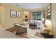 Living room with hardwood floors, stylish furniture, and a view of the backyard at 3556 Creek Run Ln, Eustis, FL 32736