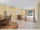 Open living area with wood-look floors, tile, a dining table, piano, and backyard access at 3556 Creek Run Ln, Eustis, FL 32736